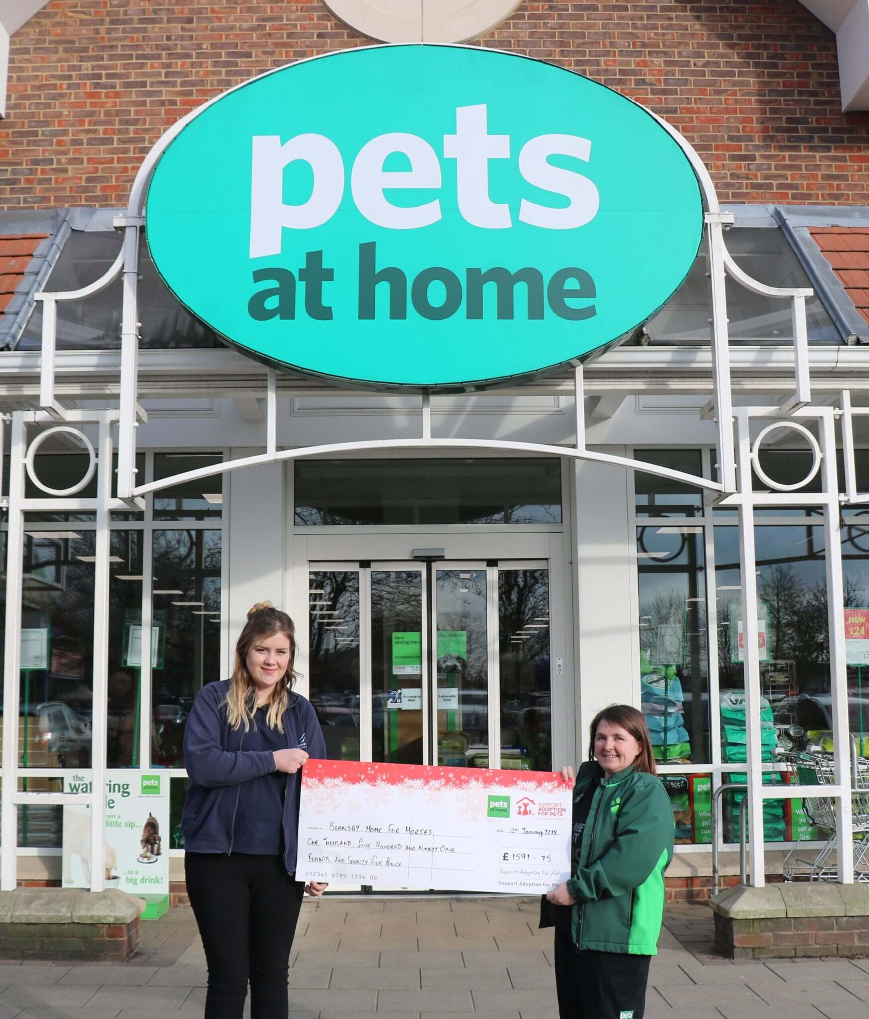 bransby member of staff accepting a cheque from pets at home