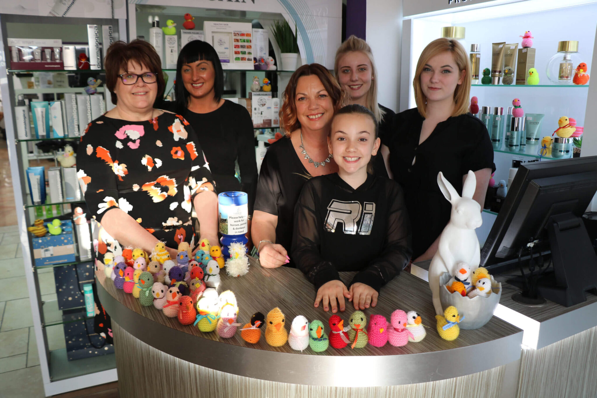 Impulse team stood at a till surrounded by knitted chicks