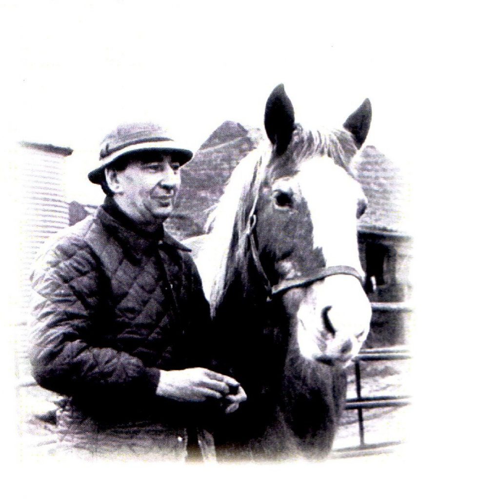 black and white photo of founder peter hunt stood next to a horse with a white nose