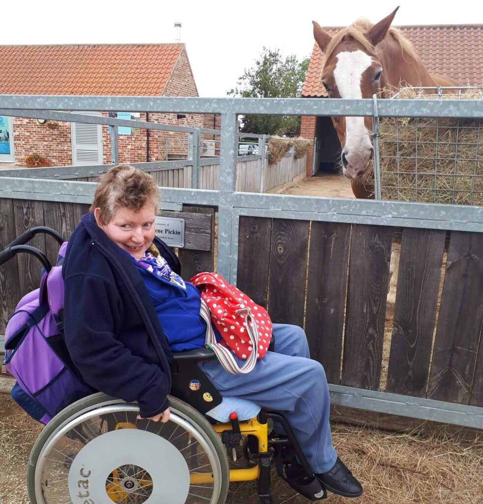 visitor spending time with a rescue horse