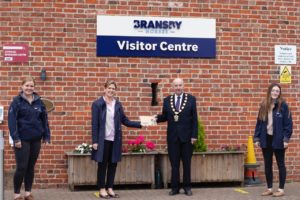 Sally Crawford presents Cllr England with his Womble Sponsorship Certificate