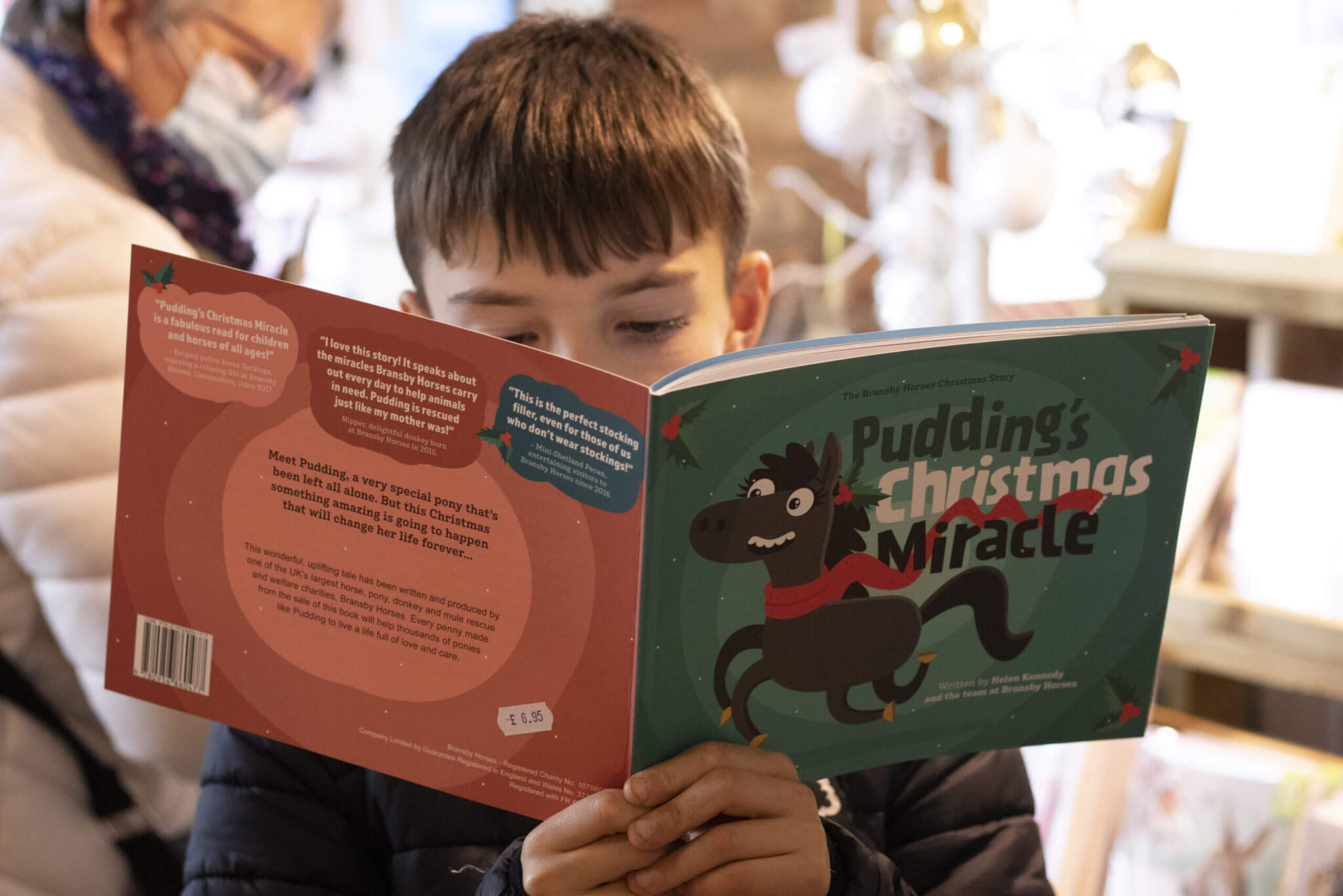 young boy reading Pudding's christmas miracle