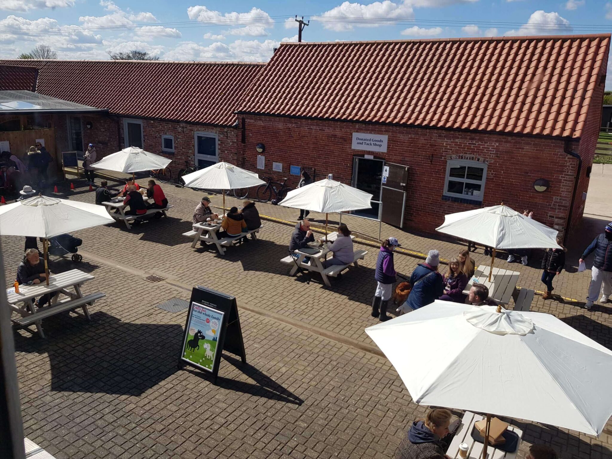 aerial image of the cafe courtyard with the table umbrellas up