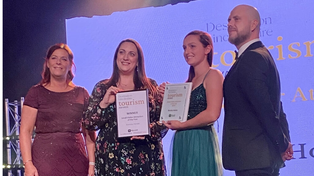 members of staff holding an award at the destination lincoln awards evening