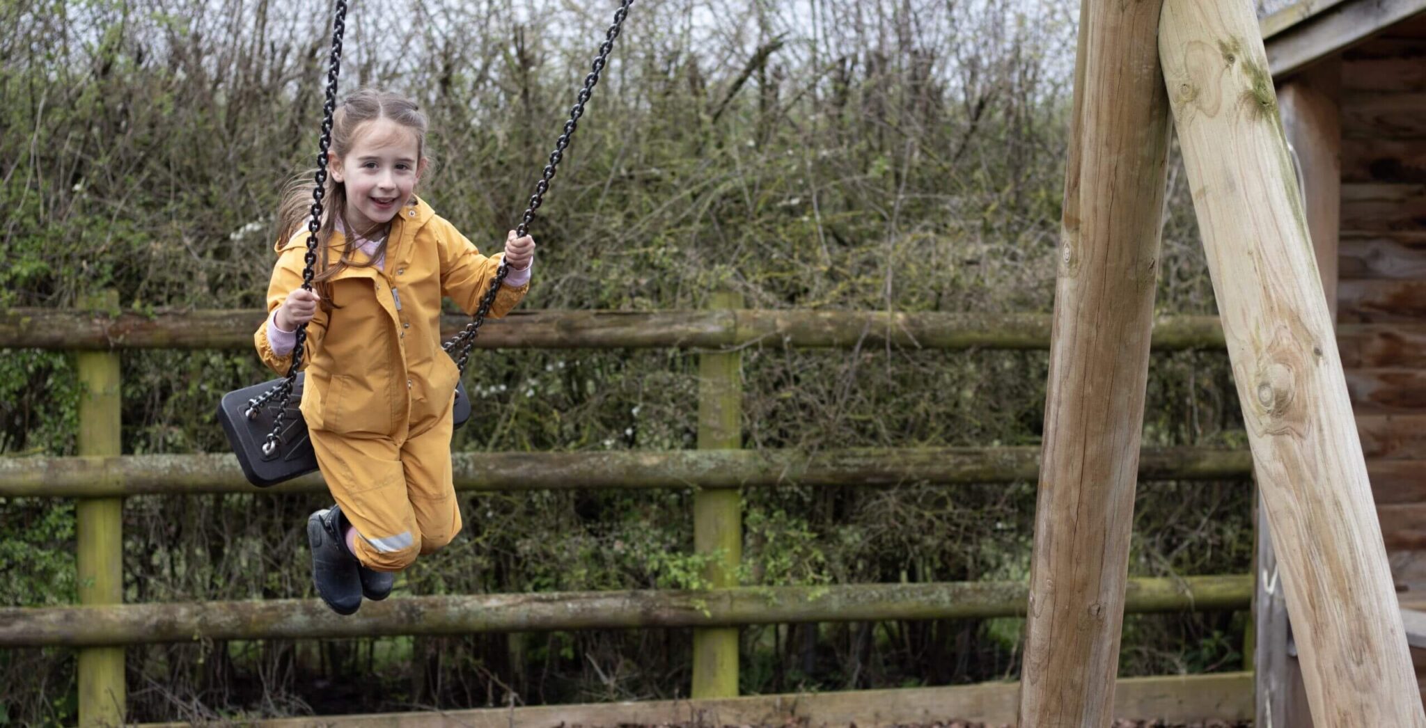 little girl on swing at playpark