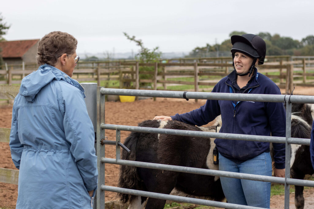 member of staff talking to a visitor