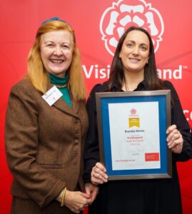 members of staff accepting an award at visit england